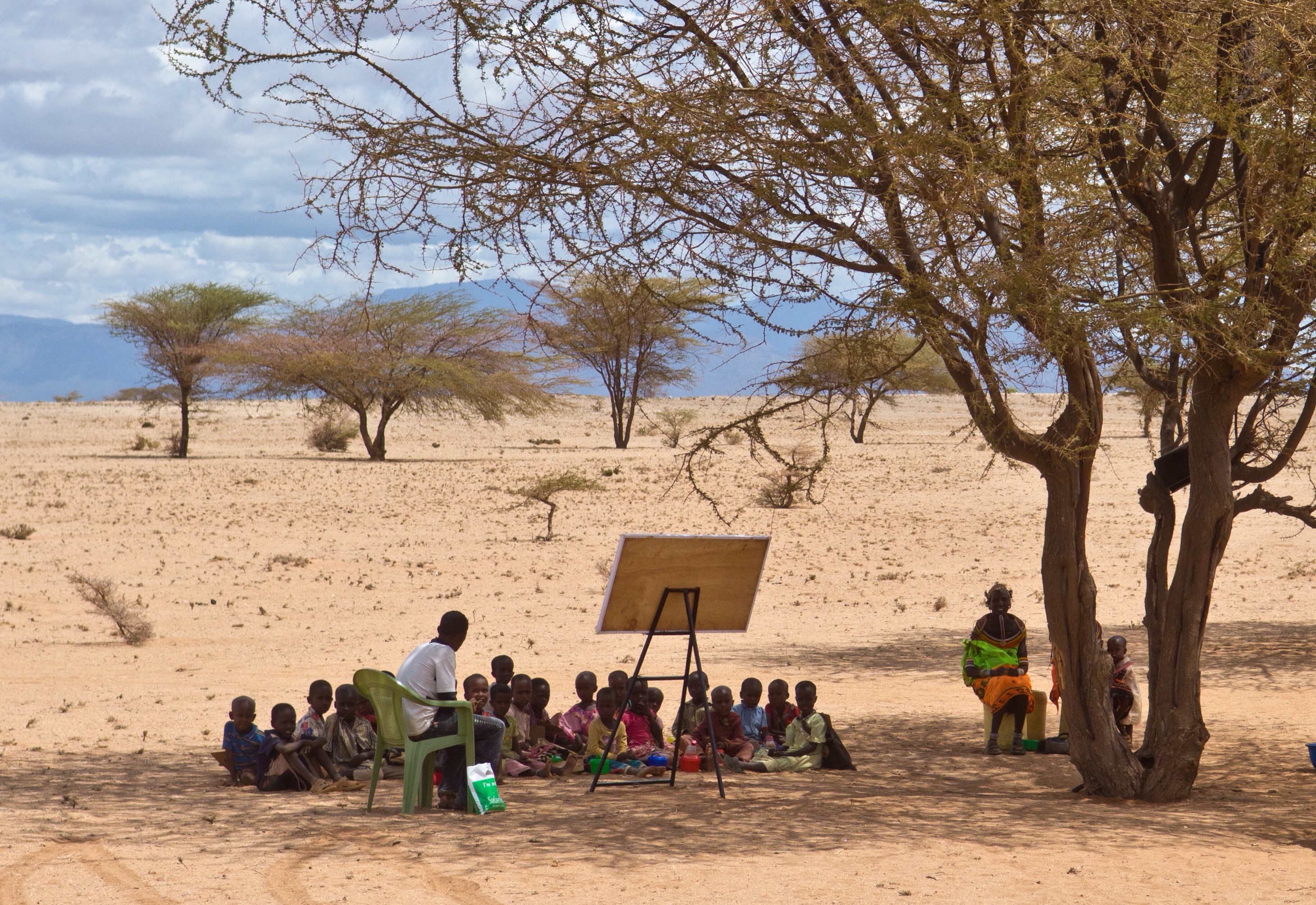 Hirkena Eysimbulyar teaches a pre-school class under a tree in the middle of the Kaisut Desert near Korr. Nick and Lyn Swanapoel with AIM have worked for 30 years in the hot, dry desert of Korr among the Rendille tribe in Korr, northern Kenya. It took 13 years to see their first convert. They realized at one point that literacy was the key to sharing Jesus and seeing people come to Christ. Literacy classes are held under trees in the middle of the desert, taught by women and men who themselves went through the literacy classes and became Christians. MAF has been a much needed service for the Swanapoels in this remote region.